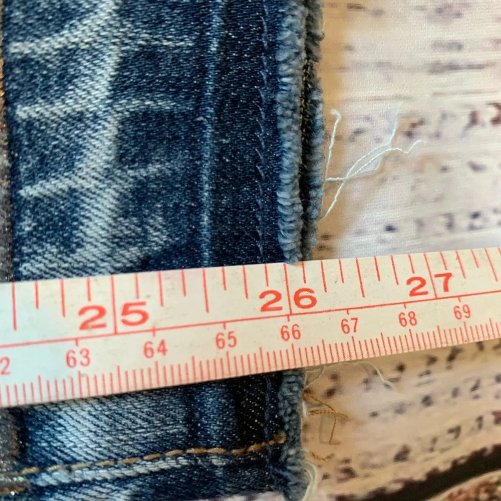 Level 99 jeans. Gold/silver design on bottom. Mid rise. Size 27.